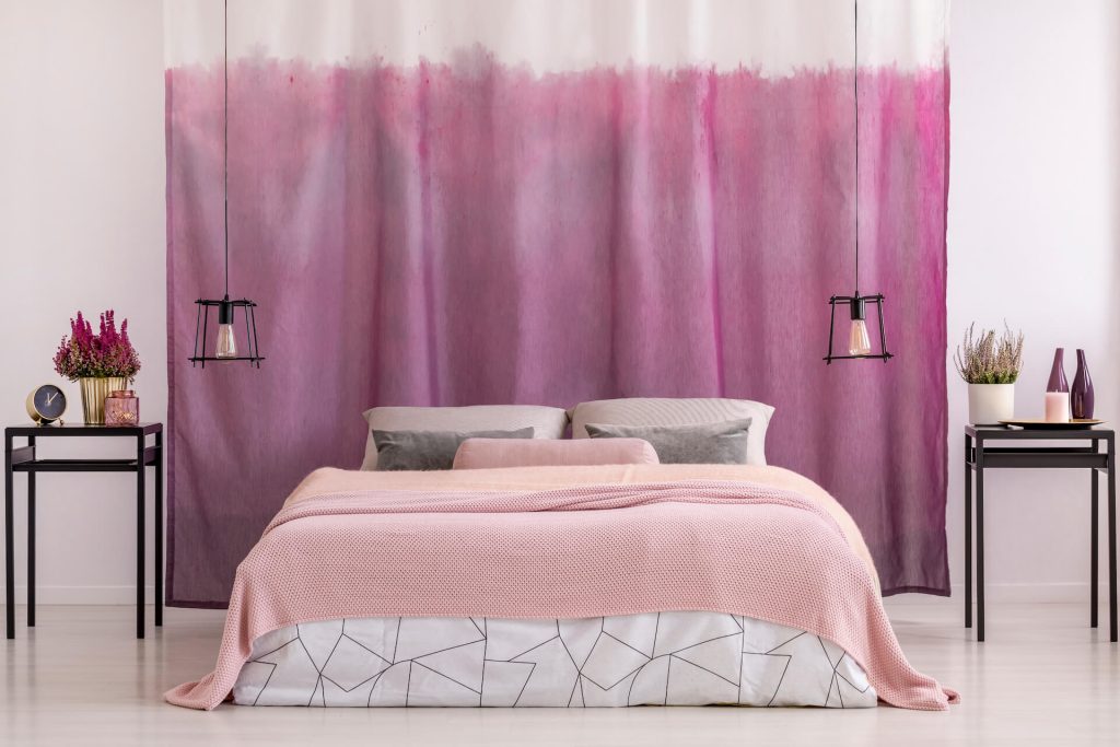 Bedroom featuring gradient pink curtains | Featured image for the History of Curtains Blog from U Blinds Australia.