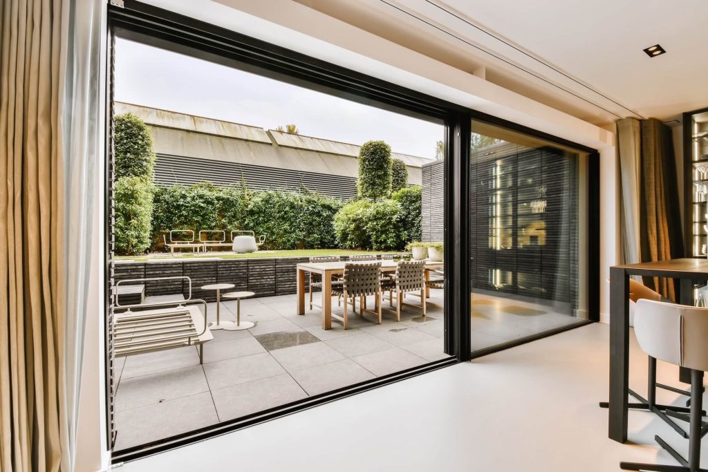 Room containing window coverings for sliding doors | Featured image for the Curtains for Sliding Doors – Our Top 5 Ideas blog by U Blinds Australia.