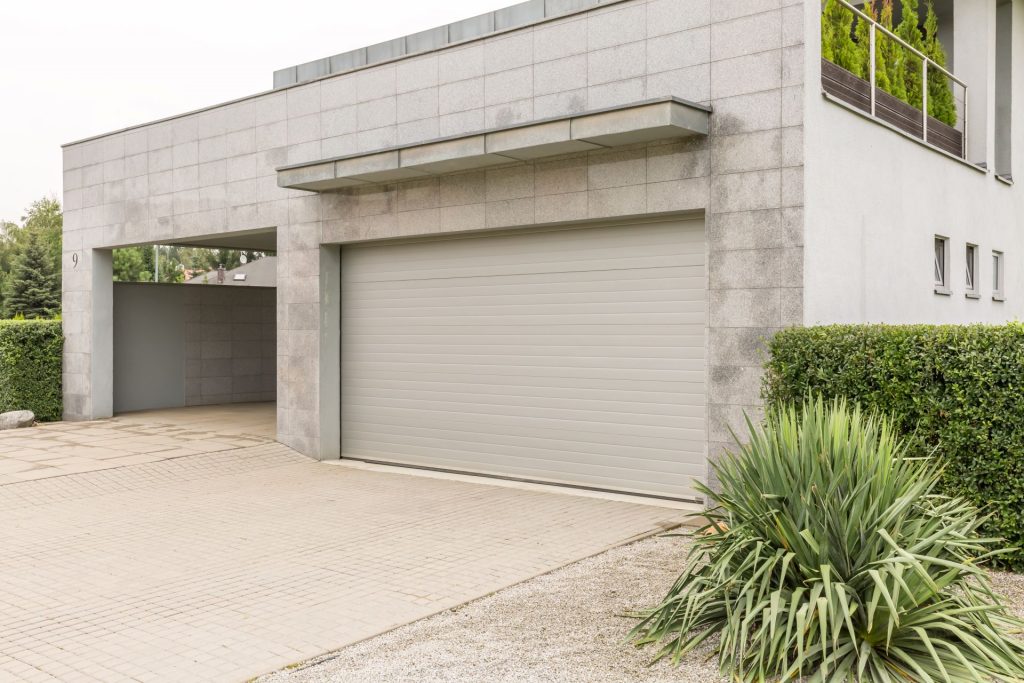 Grey Garade Door on Modern Grey Concrete Finished Home | Featured image for the Security Door Replacement Blog by U Blinds Australia.