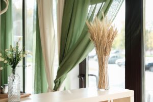 Entwined green and white curtains | Featured image the How to Layer Window Treatments - Our Top 5 Tips Blog by U Blinds Australia.