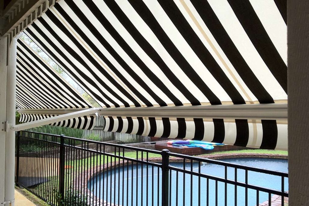 Black and white striped anwing beside a pool | Featured Image for the Adelaide Loaction Page of U Blinds Australia.