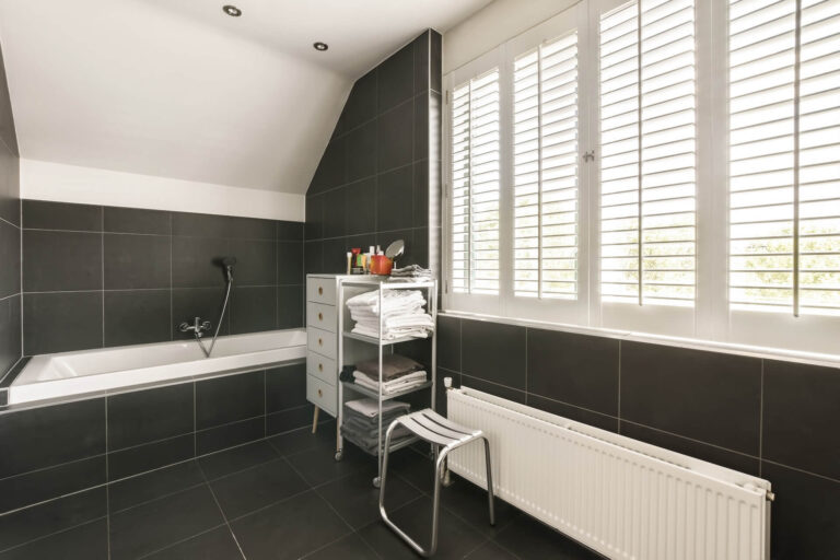 Indoor plantation shutters being used in a bathroom | Featured Image for the Plantation Shutters Page of U Blinds Australia.