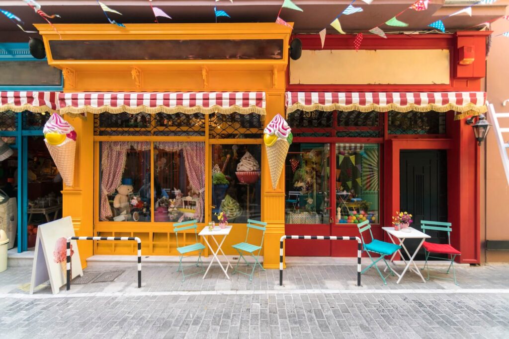 Colourful storefronts with striped awnings | Featured image for the Types of Awnings Blog on U Blinds Australia.
